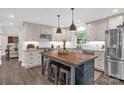 Bright kitchen featuring an island with seating, stainless appliances, and neutral custom cabinets at 323 Richmond Rd, Salisbury, NC 28144