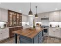 Bright kitchen with island, pendant lights, stainless appliances, granite countertops, and custom cabinetry at 323 Richmond Rd, Salisbury, NC 28144