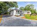 Exterior elevation showing the home's gravel driveway and low-maintenance landscaping at 403 Broad St, Kannapolis, NC 28081