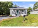 This home has beautiful curb appeal, with manicured grass and landscaping at 403 Broad St, Kannapolis, NC 28081