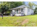 Exterior elevation showing the cozy bungalow with a covered porch and manicured lawn at 403 Broad St, Kannapolis, NC 28081