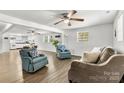 Open-concept living area with hardwood floors, ceiling fans, and plenty of natural light at 4304 S Falls St, Gastonia, NC 28056