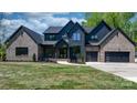 Beautiful home featuring a combination of modern black wood and brick, complemented by a well-manicured lawn at 4377 Kiser Island Rd, Terrell, NC 28682
