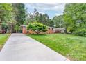 Lovely brick home with an expansive driveway and beautifully landscaped yard at 4920 Raymond Pl, Charlotte, NC 28205