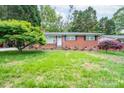Classic brick home with a tidy front yard and mature landscaping at 4920 Raymond Pl, Charlotte, NC 28205
