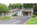 Inviting exterior showcasing the home's manicured lawn, private driveway, and attached carport at 505 2Nd Street Ne Pl # C4, Conover, NC 28613