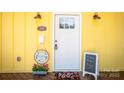 Charming yellow home featuring a welcoming white front door and decorative accents on the covered porch at 530 W Franklin St, Salisbury, NC 28144