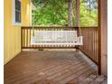 Relax on the porch with a white wooden swing and a view of the green trees at 530 W Franklin St, Salisbury, NC 28144