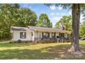 A beautiful one-story home with a covered front porch and lush green lawn at 5317 Friendly Baptist Ch Rd, Indian Trail, NC 28079