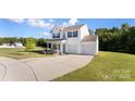 Inviting home featuring a two-car garage, manicured lawn, and classic design elements at 548 Dutch White Dr, Clover, SC 29710