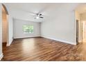 Spacious living room featuring hardwood floors and a ceiling fan at 5604 Bradford Lake Ln, Charlotte, NC 28269