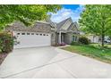 Well-maintained brick house with a two-car garage and beautiful landscaping at 5722 Kirkwynd Commons Dr, Charlotte, NC 28278