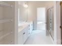 Bright bathroom boasts double sink vanity, open shelving and a glass enclosed shower at 606 Banter Ln # 30, Cramerton, NC 28032