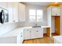 Bright kitchen features white cabinets, stainless steel appliances, light countertops, and a window at 606 Banter Ln # 30, Cramerton, NC 28032