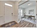 Bright foyer featuring wood floors, a white front door, and an open view of the office at 6113 Russo Ct, Lancaster, SC 29720
