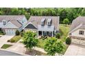 Beautiful home showcasing an inviting front porch, lush landscaping, and a well-maintained yard at 7549 Short Putt Ct, Charlotte, NC 28215