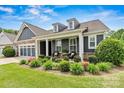 Inviting front porch featuring comfortable seating and decorative plants and flowers, adding curb appeal at 7549 Short Putt Ct, Charlotte, NC 28215
