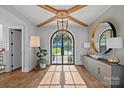 Light-filled foyer with wood floors, designer light fixture, and views of the outdoors at 7861 Live Oaks Dr, Denver, NC 28037