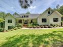 Charming two-story farmhouse-style home with black framed windows and a well-manicured front yard at 7927 Fairmont Dr, Waxhaw, NC 28173