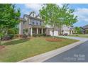 A well maintained home with a green lawn, healthy landscaping, and easy access to neighborhood sidewalks at 866 Tyne Dr, Fort Mill, SC 29715