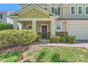 Inviting entrance with a covered porch, supported by white columns and framed by manicured bushes at 8919 Oransay Way, Charlotte, NC 28278