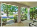 View from the covered front porch showcasing the serene neighborhood, lush greenery, and mature trees at 8919 Oransay Way, Charlotte, NC 28278