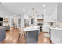 Bright, modern kitchen with a large island, stainless steel appliances, and pendant lighting at 9809 Hanover Hollow Dr, Charlotte, NC 28210