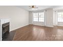 Bright living room with fireplace, hardwood floors, and large windows at 11011 Alderbrook Ln, Charlotte, NC 28270