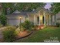 Enhanced image of single-Gathering home with a manicured front lawn, beautiful landscaping and covered porch at 11913 Little Stoney Ct, Charlotte, NC 28269