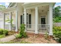 Inviting front porch with white columns and railings, perfect for enjoying the outdoors at 11913 Little Stoney Ct, Charlotte, NC 28269