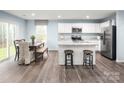 Bright kitchen features stainless steel appliances, white cabinets and a dining area at 120 Millstream Dr, China Grove, NC 28023