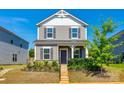 Inviting two-story home with gray siding, front steps, and attractive landscaping at 13210 Kenworth Rd, Charlotte, NC 28278