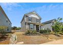 Charming two-story home with landscaped yard, dark shutters, and a cozy covered front porch at 13210 Kenworth Rd, Charlotte, NC 28278