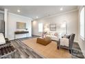 Comfortable living room featuring stylish furniture, a soft rug, and recessed lighting at 13210 Kenworth Rd, Charlotte, NC 28278