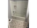 Well-lit bathroom featuring a clean white bathtub, shower combo, and neutral-tiled floor at 1343 Flint Hill St, Rock Hill, SC 29730