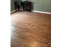 Inviting living room showcasing laminate wood flooring, complemented by green walls and classic trim details at 1343 Flint Hill St, Rock Hill, SC 29730