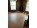 Spacious living room featuring wood-paneled walls and laminate wood flooring, perfect for relaxing or entertaining at 1343 Flint Hill St, Rock Hill, SC 29730