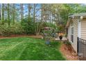 Spacious backyard with a stone patio, mature trees, and lush green lawn at 1509 Kirkbridge Ct, Matthews, NC 28105