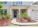 Close-up of the front porch with a seating bench and a charming black door at 15108 Autumn Sage Dr, Charlotte, NC 28278