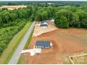 Aerial view showcases the location of a single-story home with surrounding wooded areas at 15700 Stokes Ferry Rd, Richfield, NC 28137