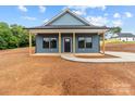Inviting single-story home with a classic covered porch and stylish blue siding at 15700 Stokes Ferry Rd, Richfield, NC 28137