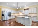 Spacious kitchen with white cabinets, granite countertops, stainless steel appliances, and a large center island at 16919 Hedgerow Park Rd, Charlotte, NC 28277
