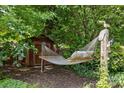 Relaxing backyard space featuring a hammock and storage shed at 2006 Holly Villa Cir, Indian Trail, NC 28079