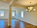 Spacious dining room with hardwood floors, white walls, and a contemporary chandelier at 2019 Puddle Pond Rd, Indian Trail, NC 28079