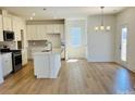 Bright, modern kitchen with stainless steel appliances, a center island, and hardwood floors at 2019 Puddle Pond Rd, Indian Trail, NC 28079