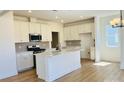 Modern kitchen with white cabinetry, stainless steel appliances, and a large center island at 2019 Puddle Pond Rd, Indian Trail, NC 28079