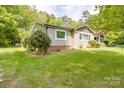 Quaint home featuring a blend of stone and siding, a neatly maintained lawn, and mature trees at 20337 Nc Hwy 73 Hwy, Albemarle, NC 28001