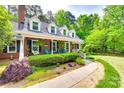 Well-maintained brick home with inviting front porch, lush landscaping, and a sidewalk entrance at 2062 High Pines Rd, Rock Hill, SC 29732