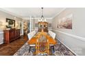 Sophisticated dining room featuring a large dining table, hardwood floors, and a decorative china cabinet at 2254 Donnington Nw Ln, Concord, NC 28027