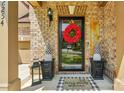 Eye-catching entryway with a cheerful wreath, stylish planters, and a welcoming 